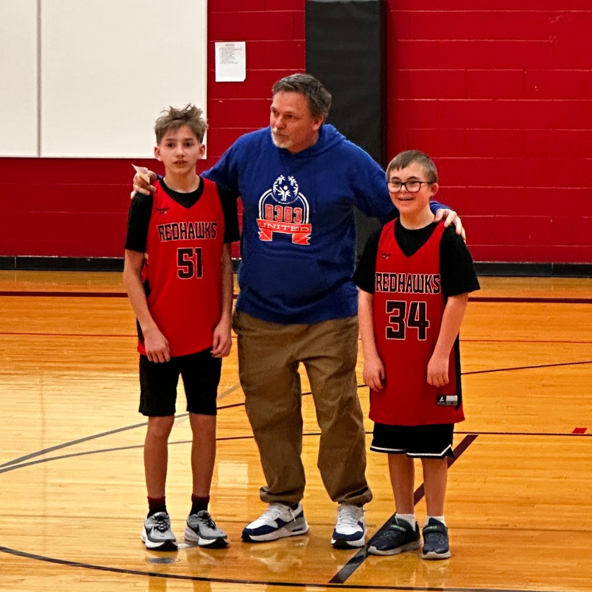 Joshua Harman (left), Mr. Massie (center), and Blake Garner (right) huddling together.
